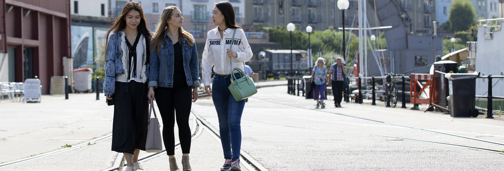 students walking by the harbour